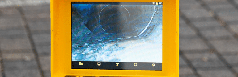 A drain cleaning company checks a blocked drain with a camera before flushing it out.